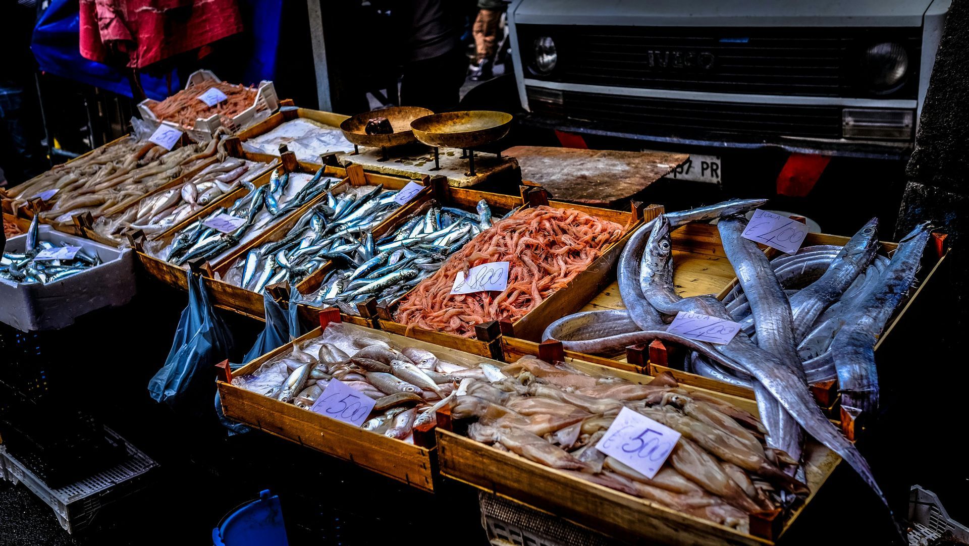 Several trays of fish are lined up on a table