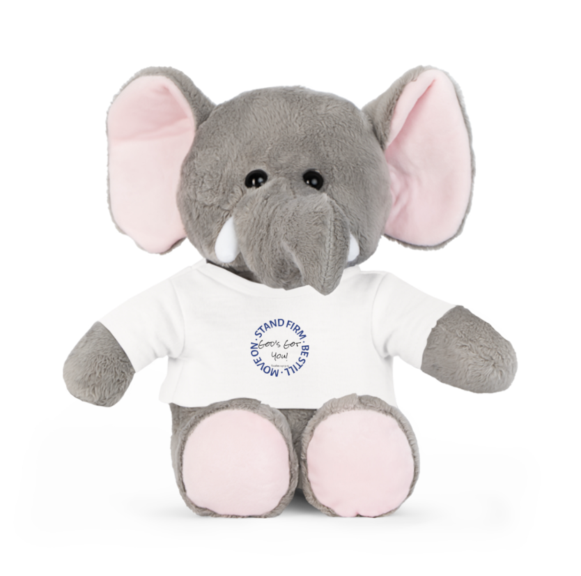 A grey stuffed elephant with large pink ears wearing a white t-shirt with a blue circular text design on the front.