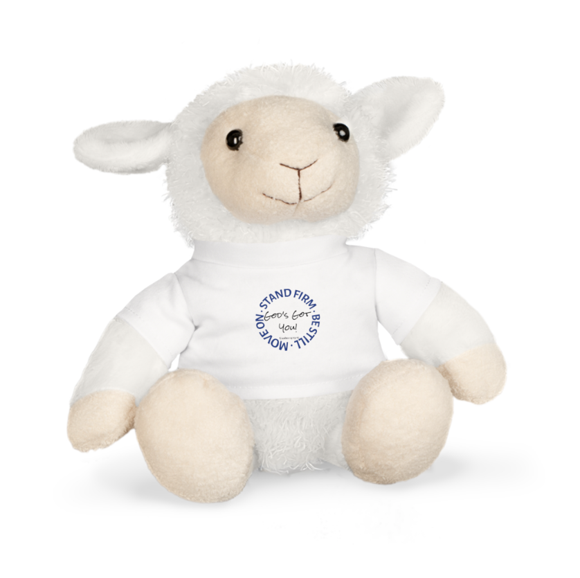 A grey stuffed elephant with large pink ears wearing a white t-shirt with a blue circular text design on the front.