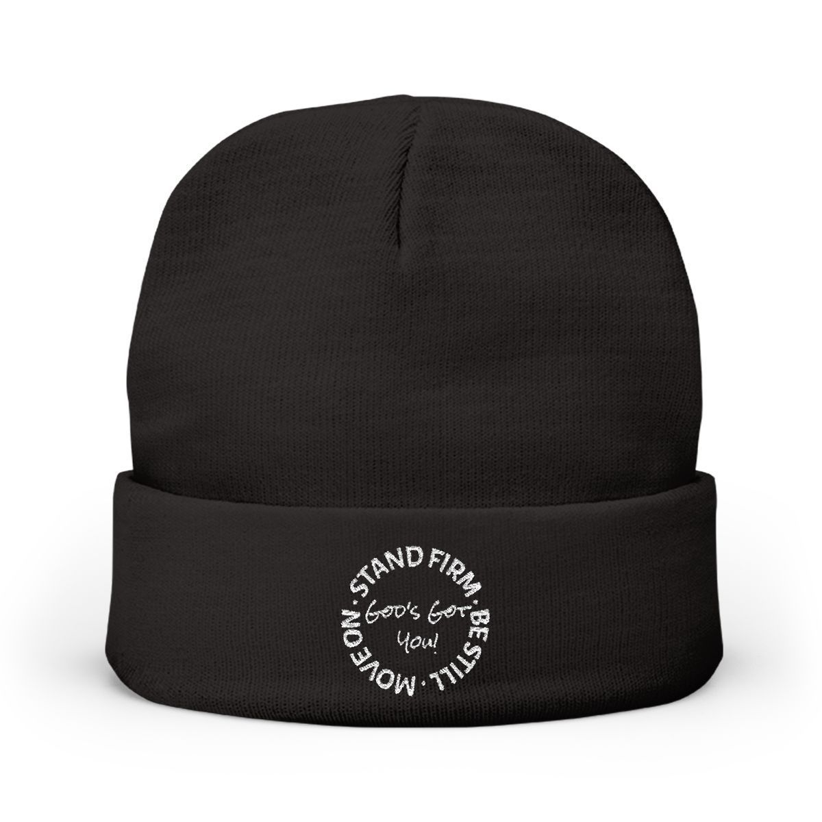 A black knit beanie with a white circular emblem containing the text