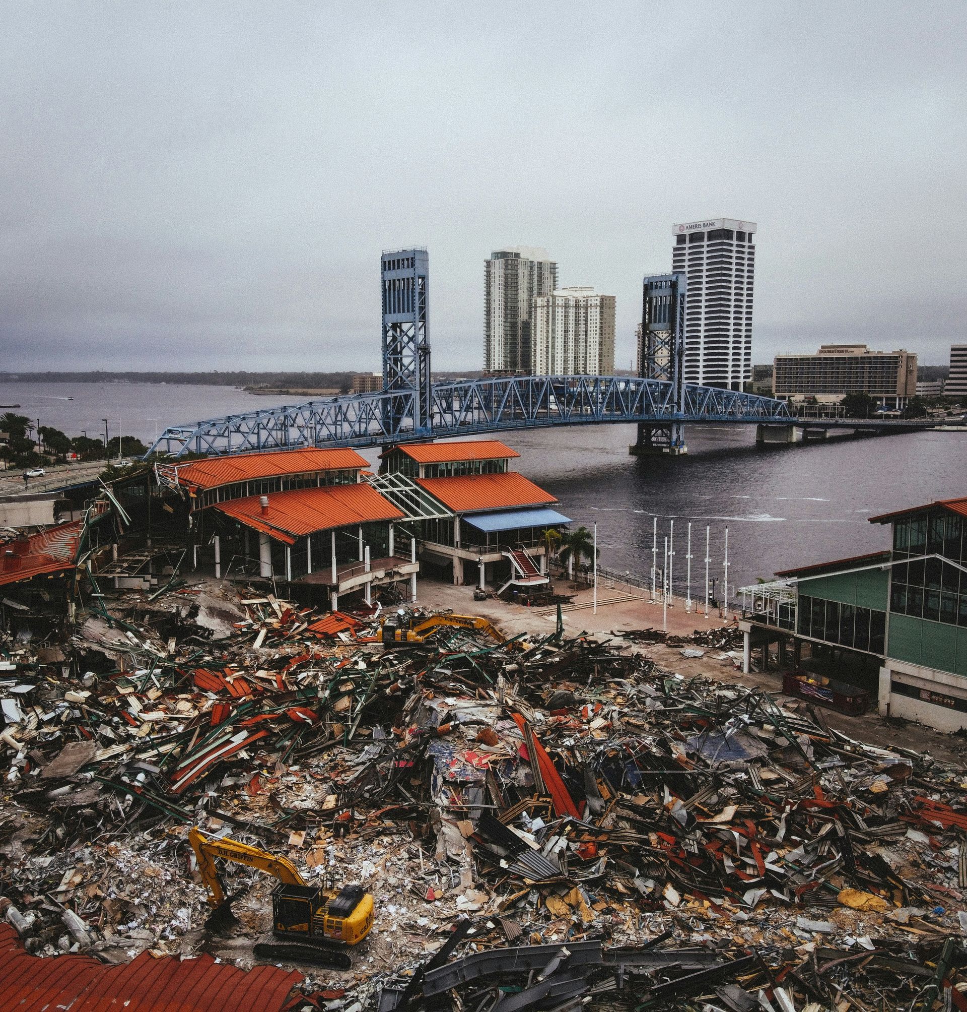 A pile of rubble with a bridge in the background