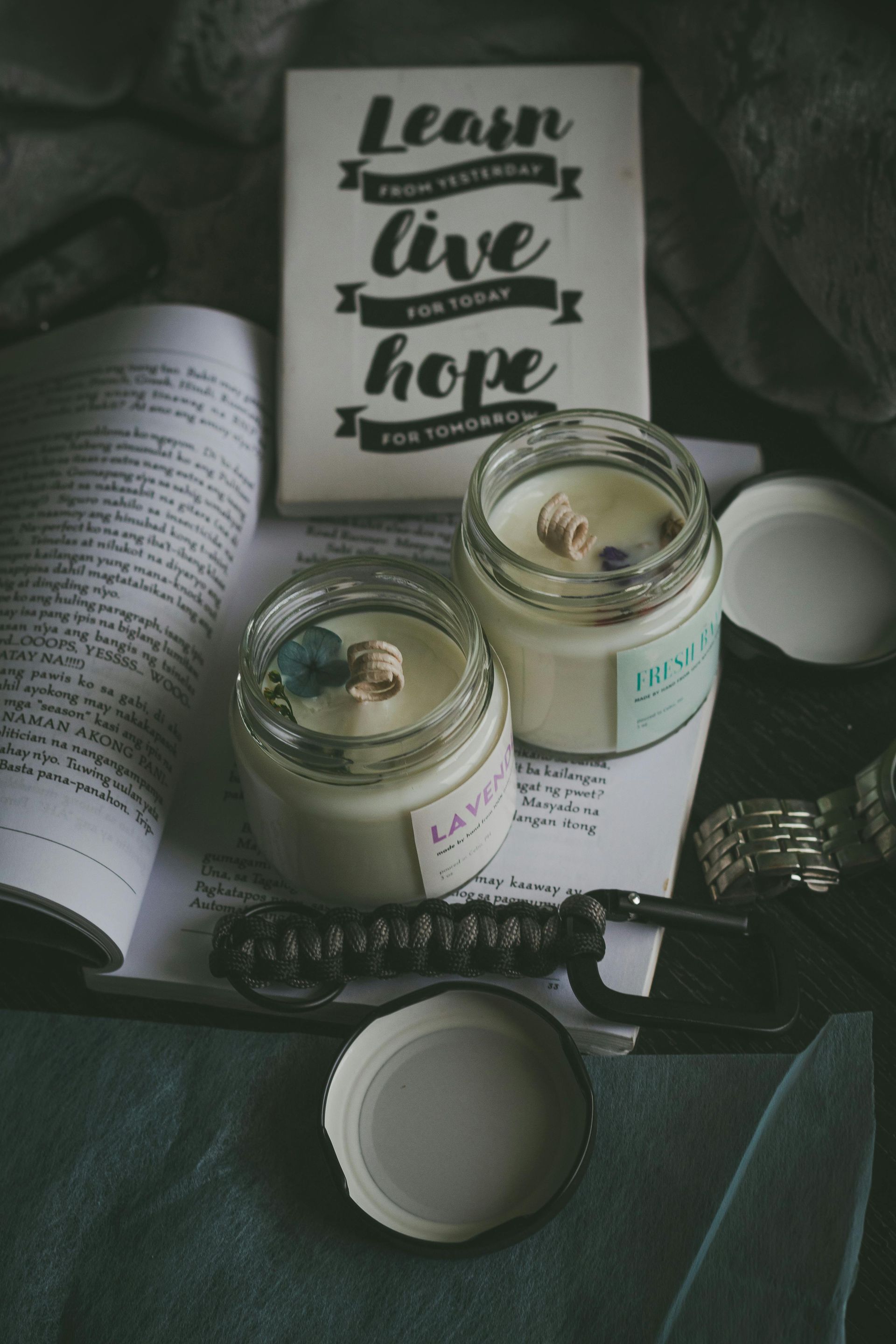 Two lit candles, open book, and