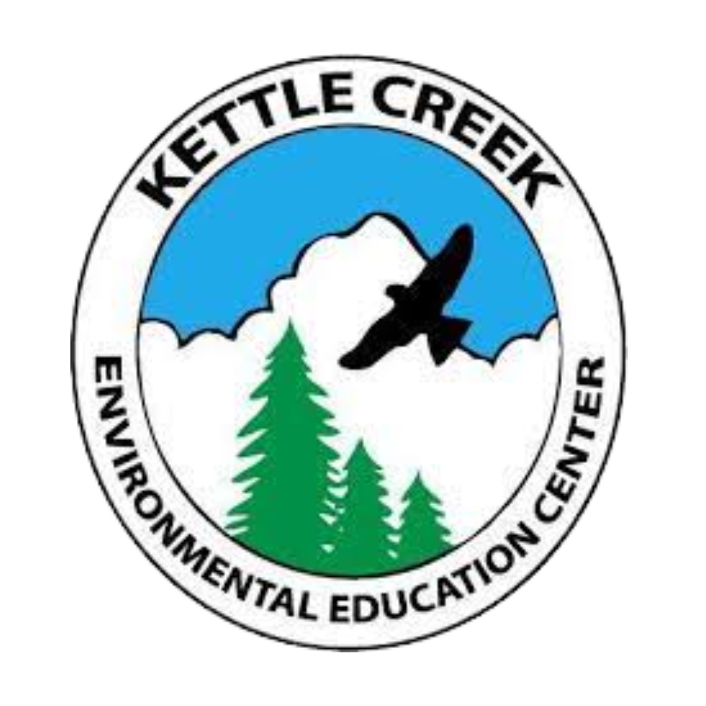 The kettle creek environmental education center logo has a bird flying over a mountain and trees.