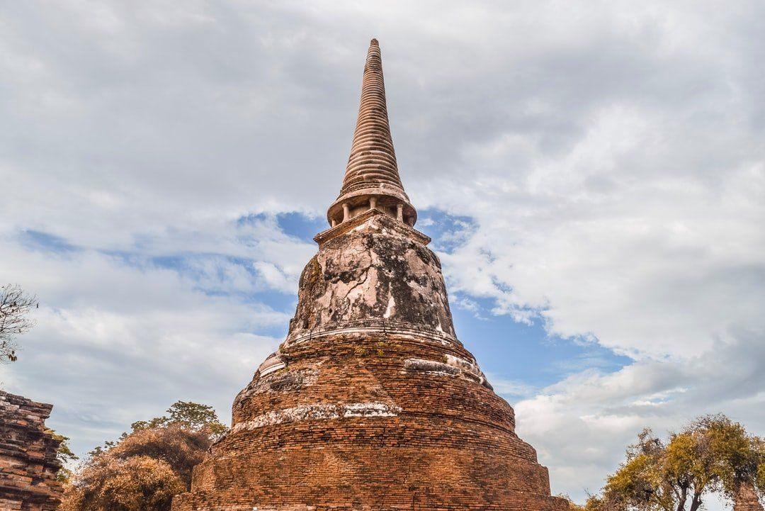 A large brick pagoda with a blue sky in the background.