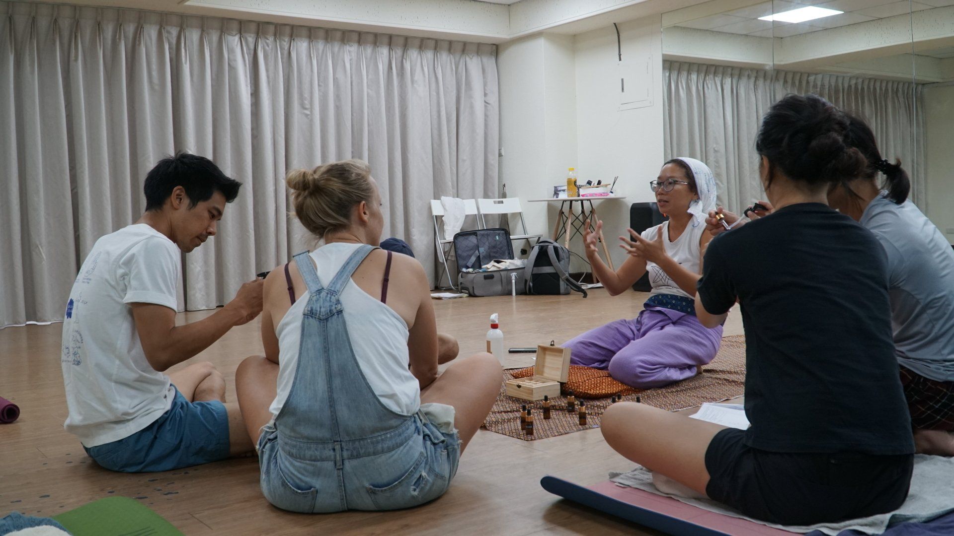 A group of people are sitting on the floor in a room.