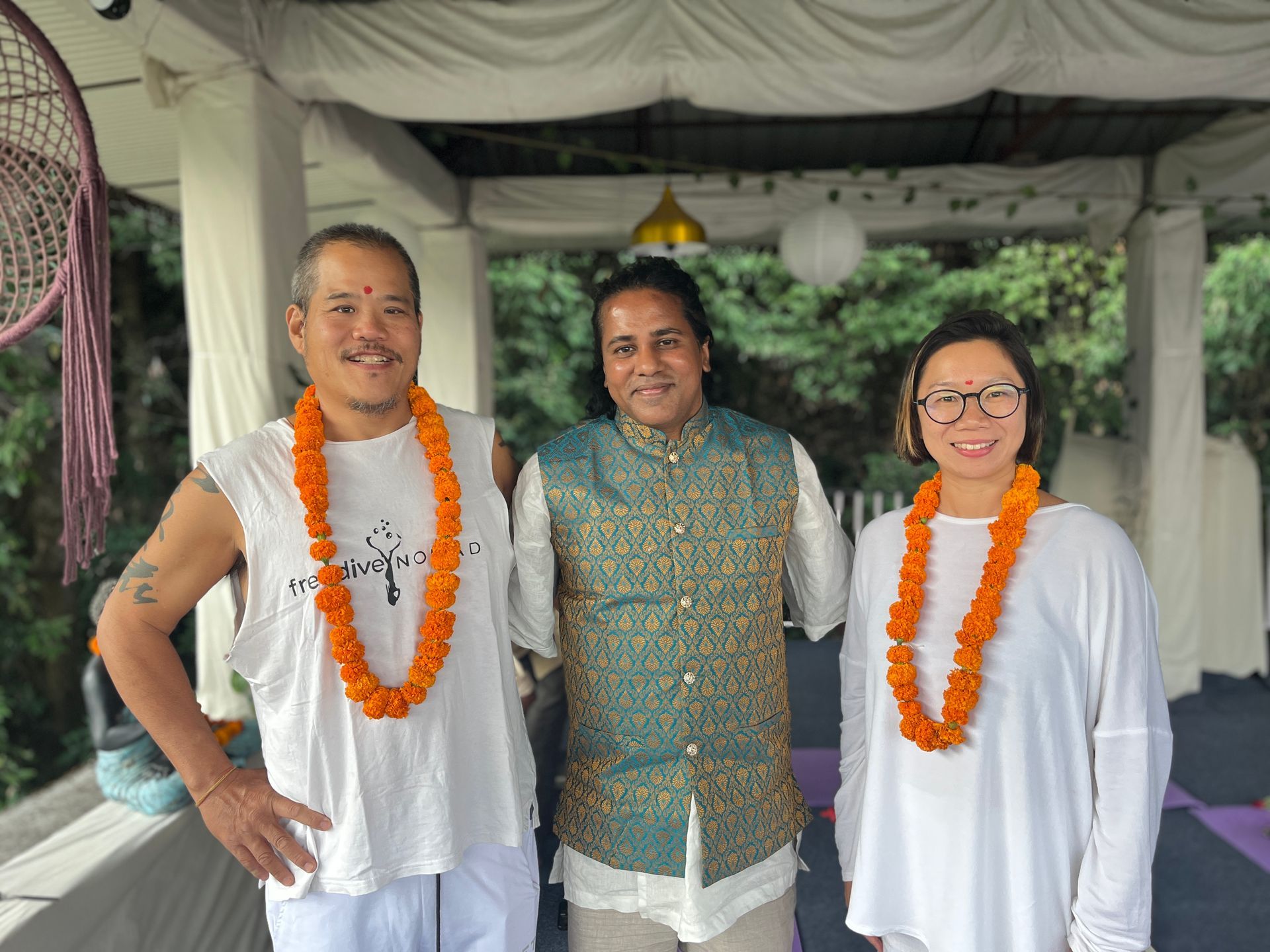 A man and two women are posing for a picture together.