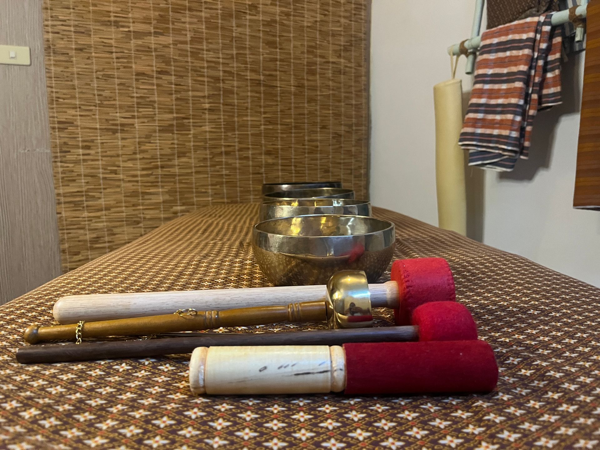 A table with bowls and sticks on it in a room.