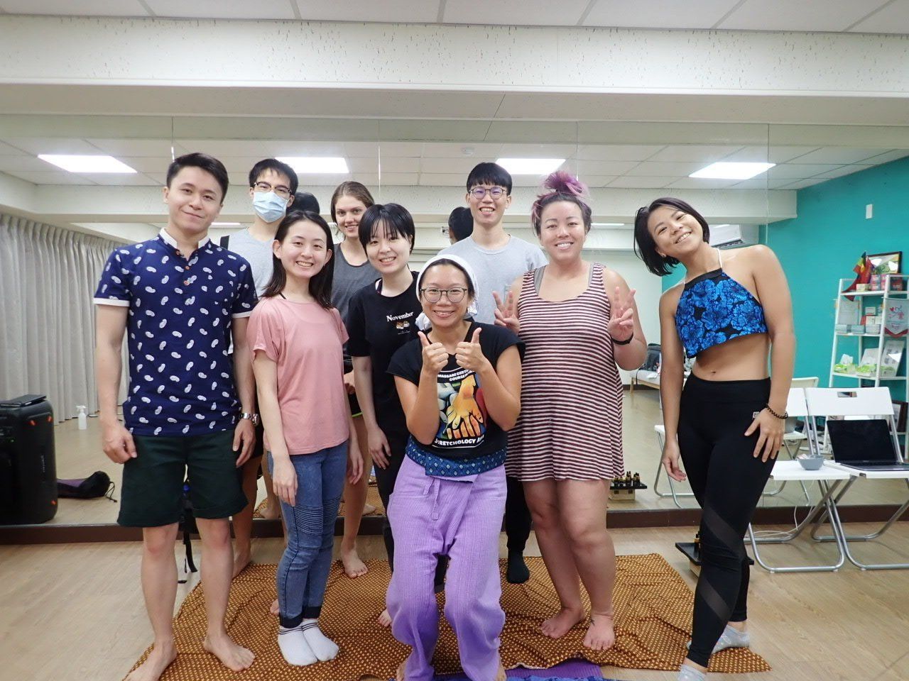 A group of people are posing for a picture in a room.