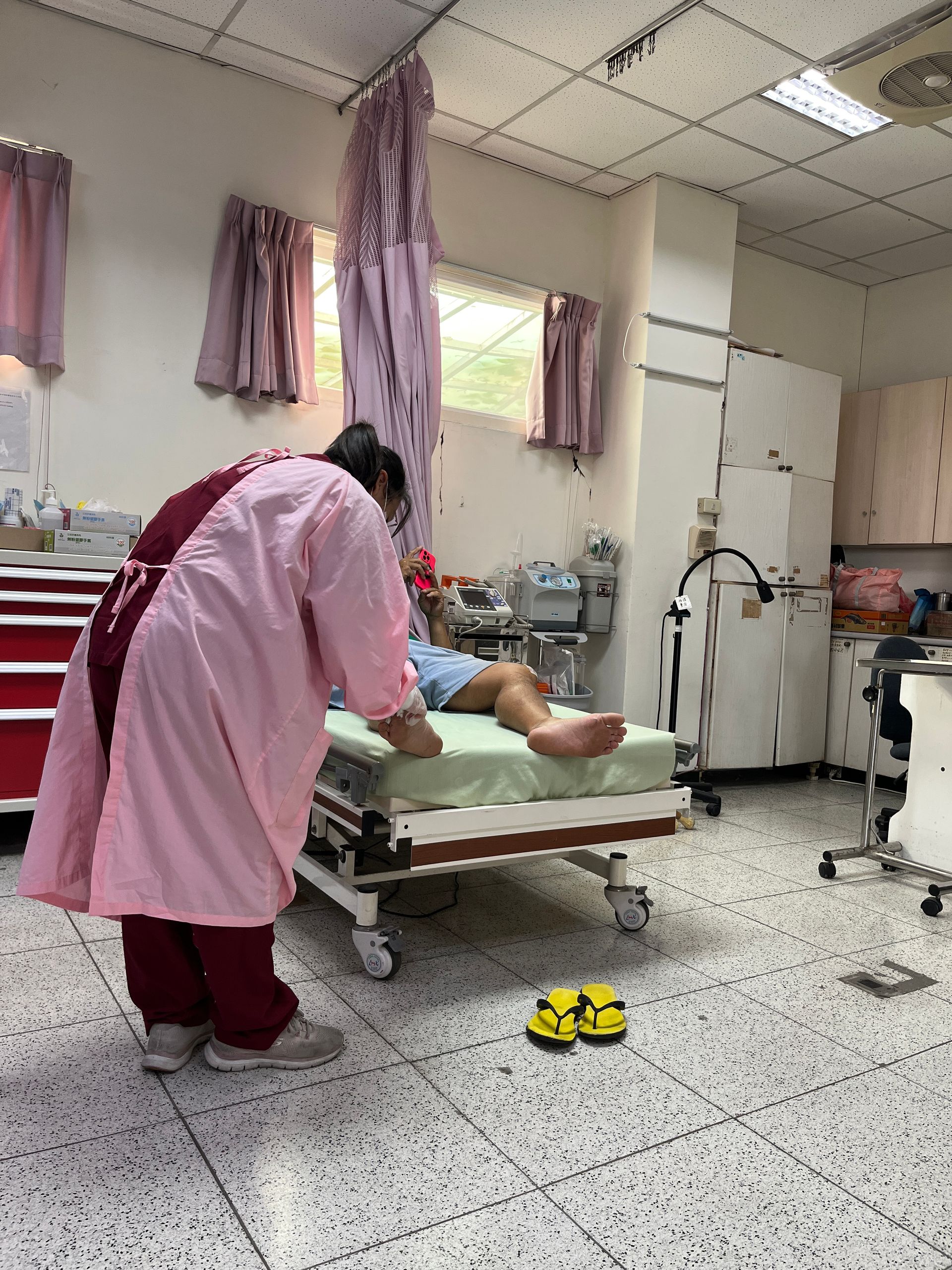 A nurse is standing next to a patient in a hospital bed.