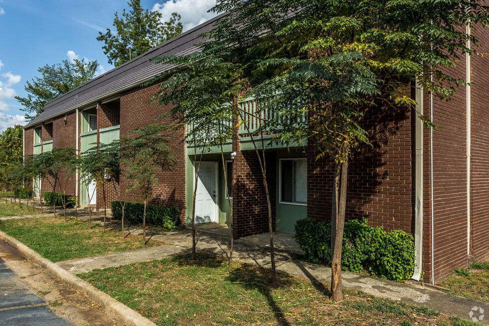 a brick apartment building with a green balcony