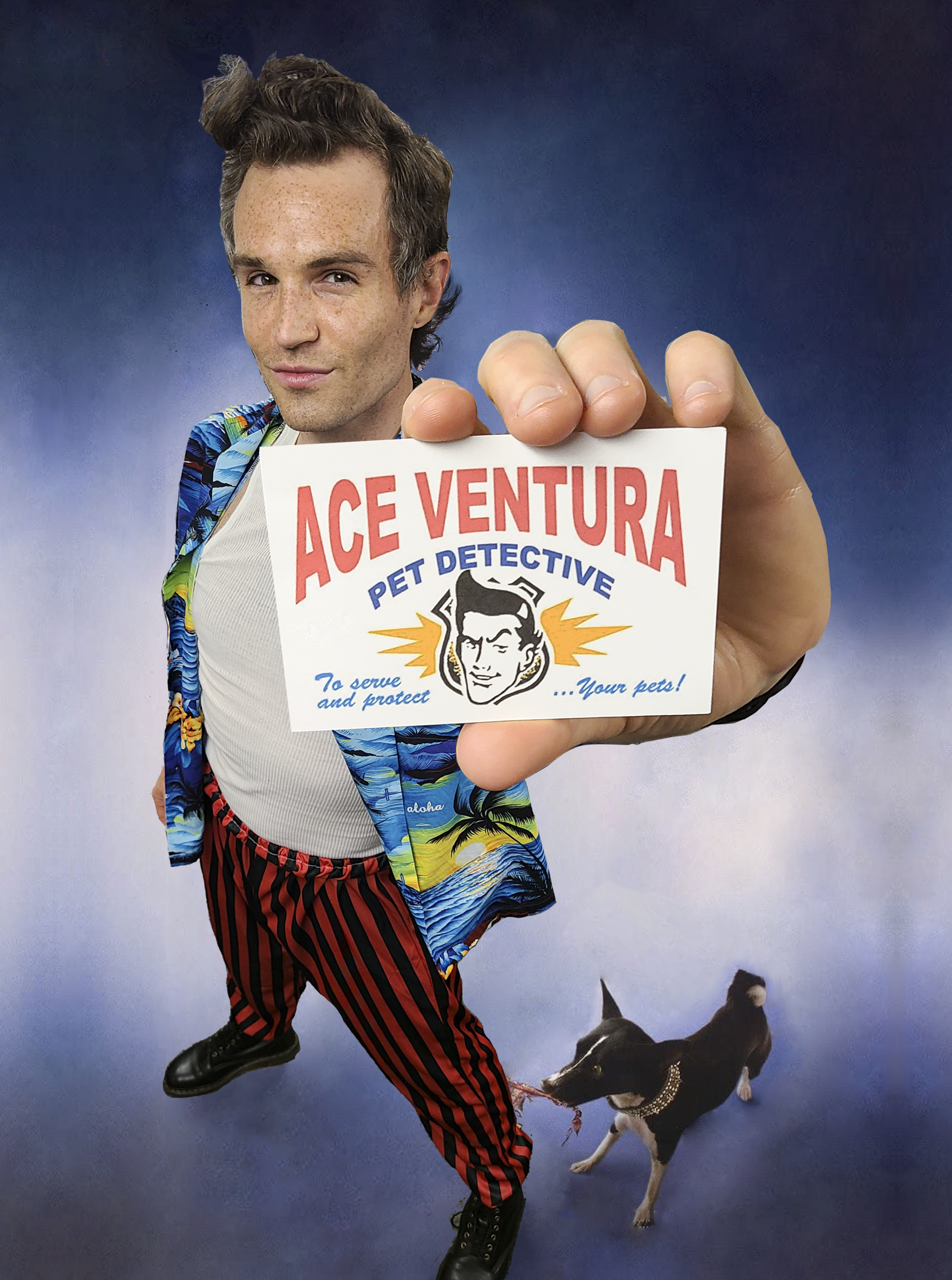 Ace Ventura holding a card, with dog at his feet. He wears a patterned jacket, striped pants, and has slicked hair.