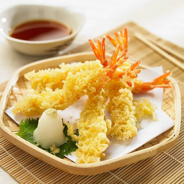 Tempura shrimp and vegetables on a plate with dipping sauce