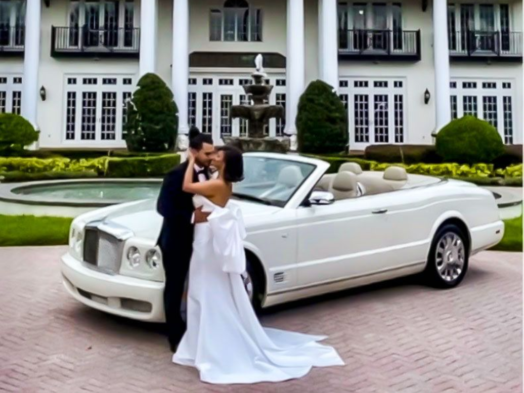 Exotic Limo Orlando Newlyweds pose by a white convertible in front of a grand white