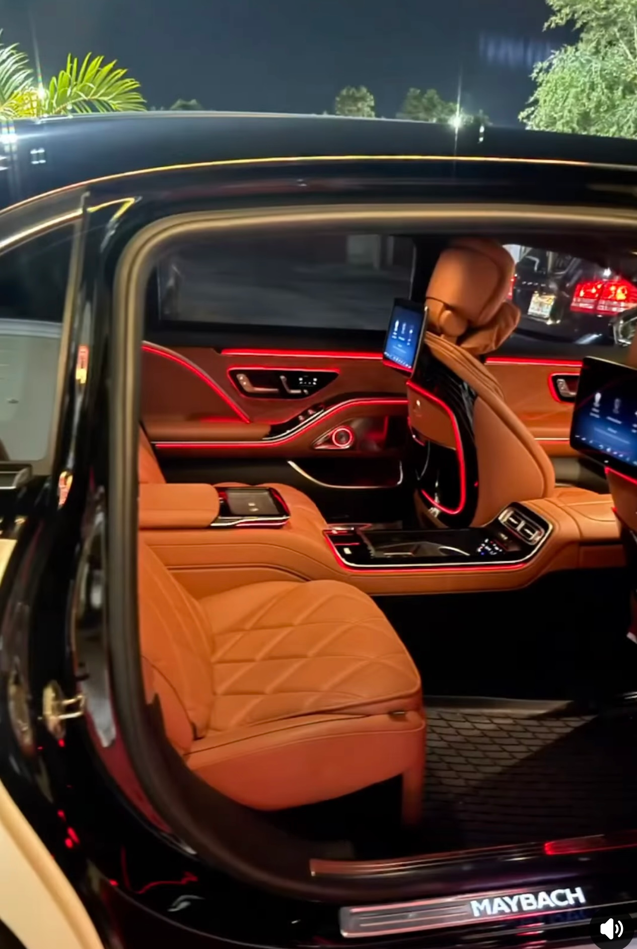 Exotic Limo Orlando Interior of a black Maybach with tan leather seats and red ambient lighting.