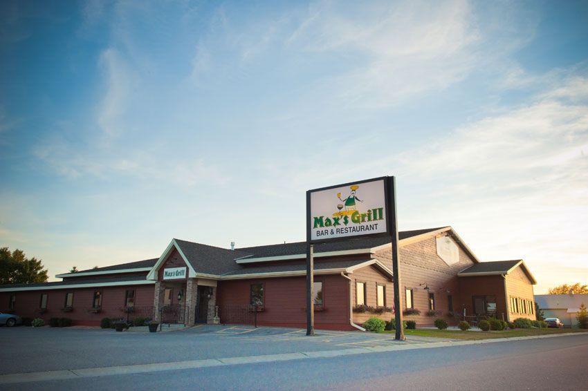 Brick restaurant building at sunset with a roadside sign reading Brick restaurant building at sunset with a roadside sign reading