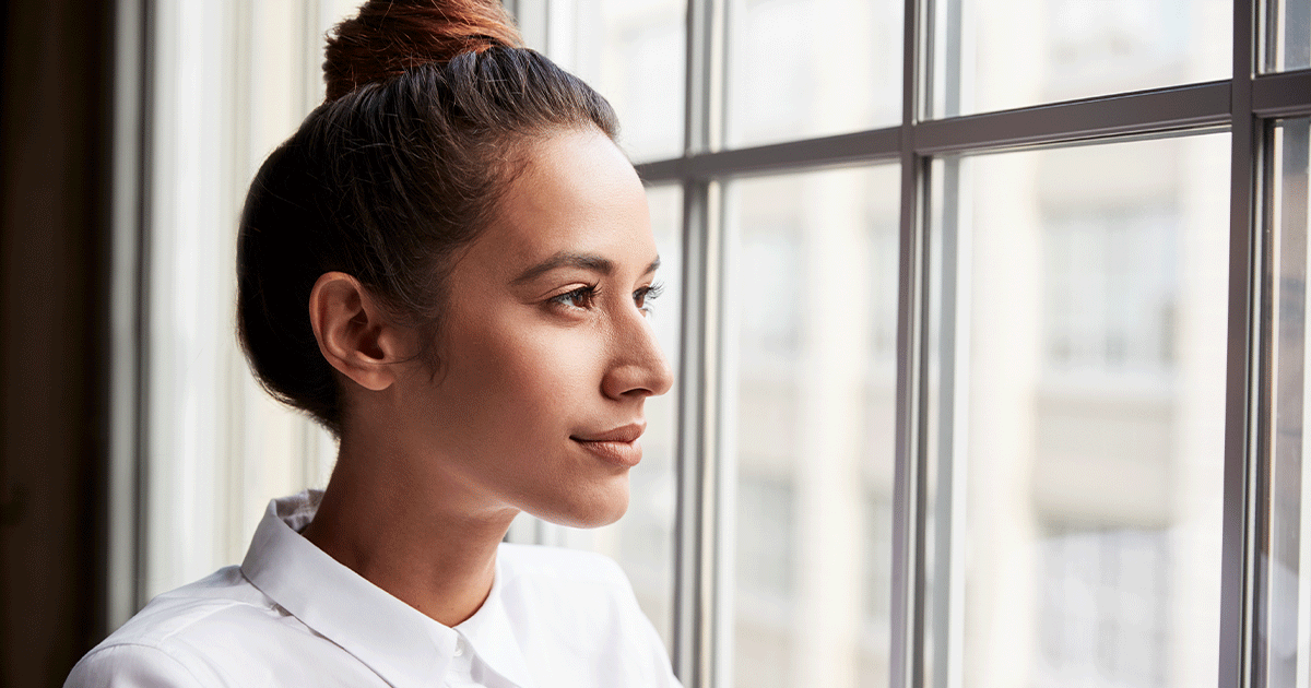 Young woman thoughtfully learning about the abortion pill before making a pregnancy decision.