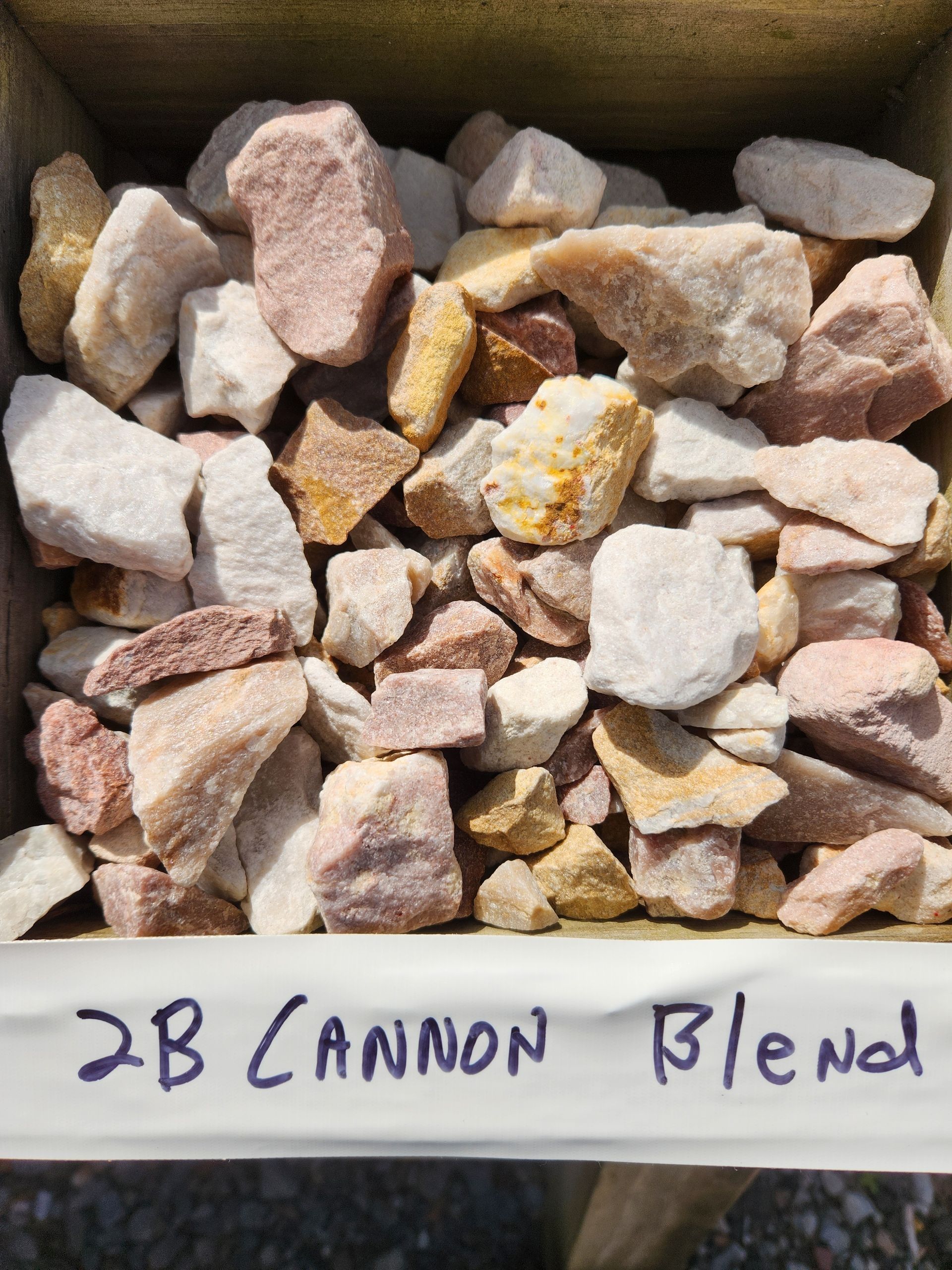 Open box of pink, white, and tan rocks labeled “2B Cannon Blend”