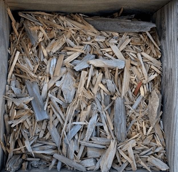 Wood chips and splinters inside a small square wooden box
