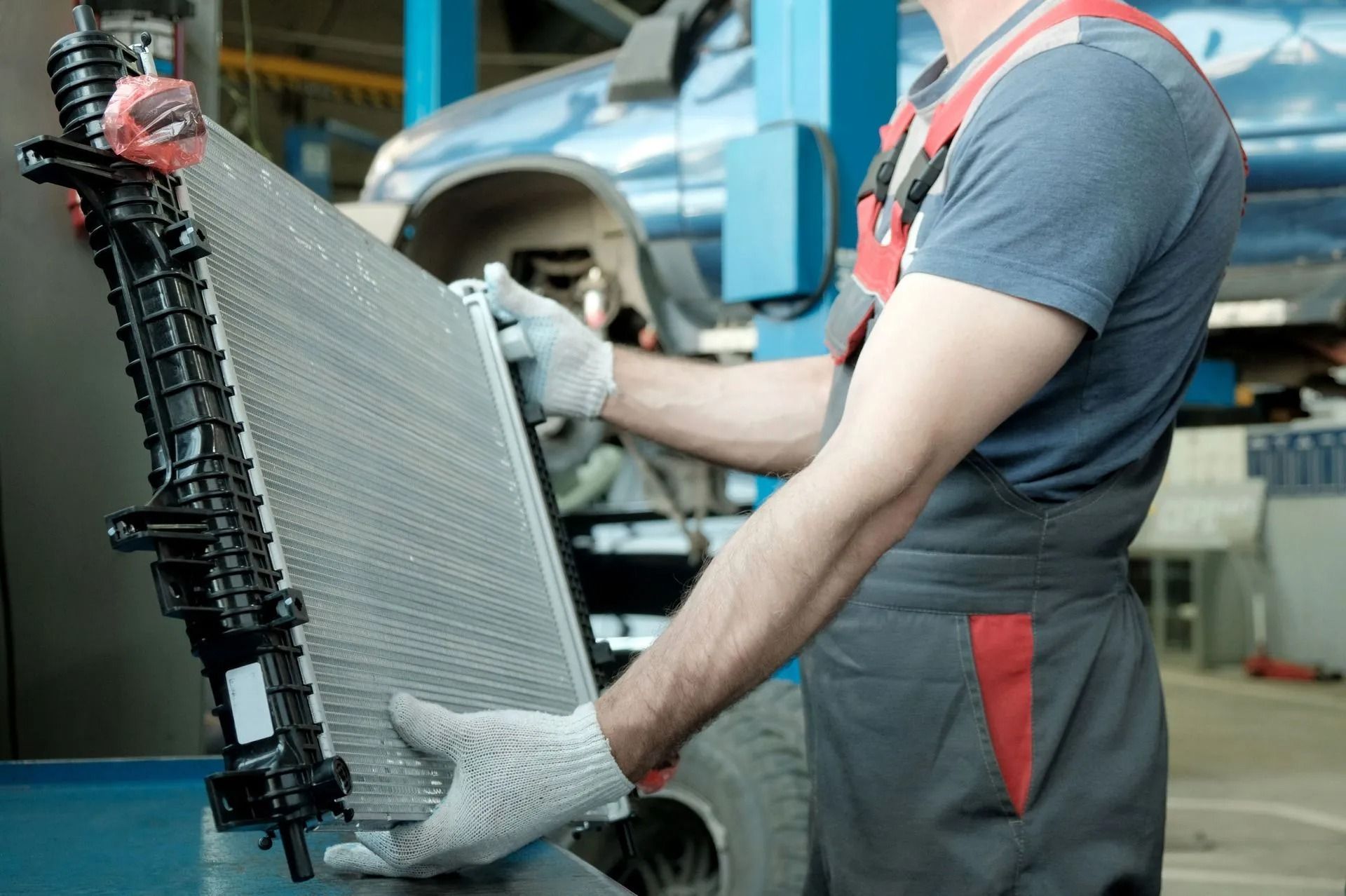 Car Mechanic Holding a Auto Radiator
