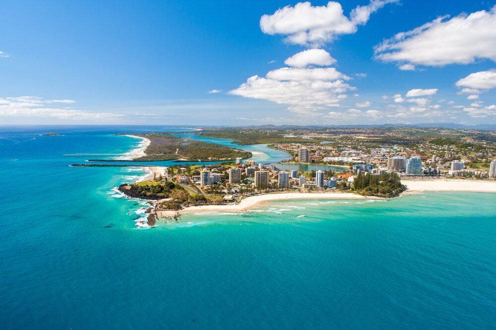 An Aerial View of a City on a  Island in the Middle of the Ocean  — Tweed Heads Coolangatta Taxi Service In Coolangatta, QLD