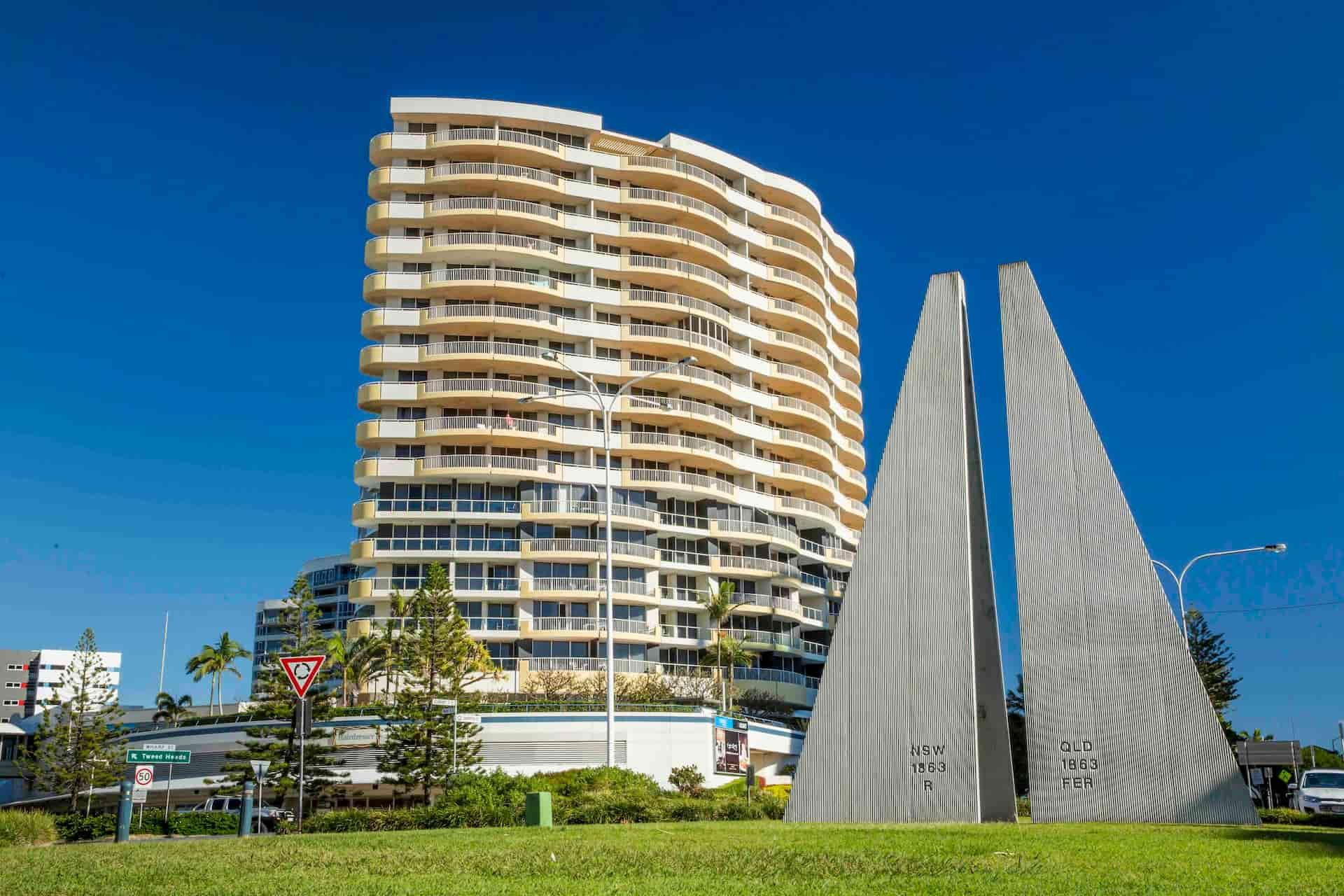 A Tall Building With a Sculpture in Front of It  — Tweed Heads Coolangatta Taxi Service In Tweed Heads, NSW