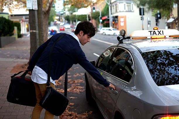 A Man is Getting Into a Taxi on the Side of the Road  — Tweed Heads Coolangatta Taxi Service In Tweed Heads, NSW