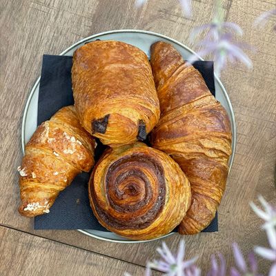 Baked goods including a butter croissant, a cinnamon swirl, vanilla croissant and pain au chocolat