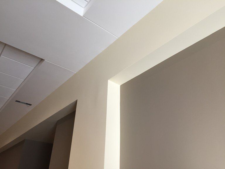 Looking up at the ceiling of a room with a window.