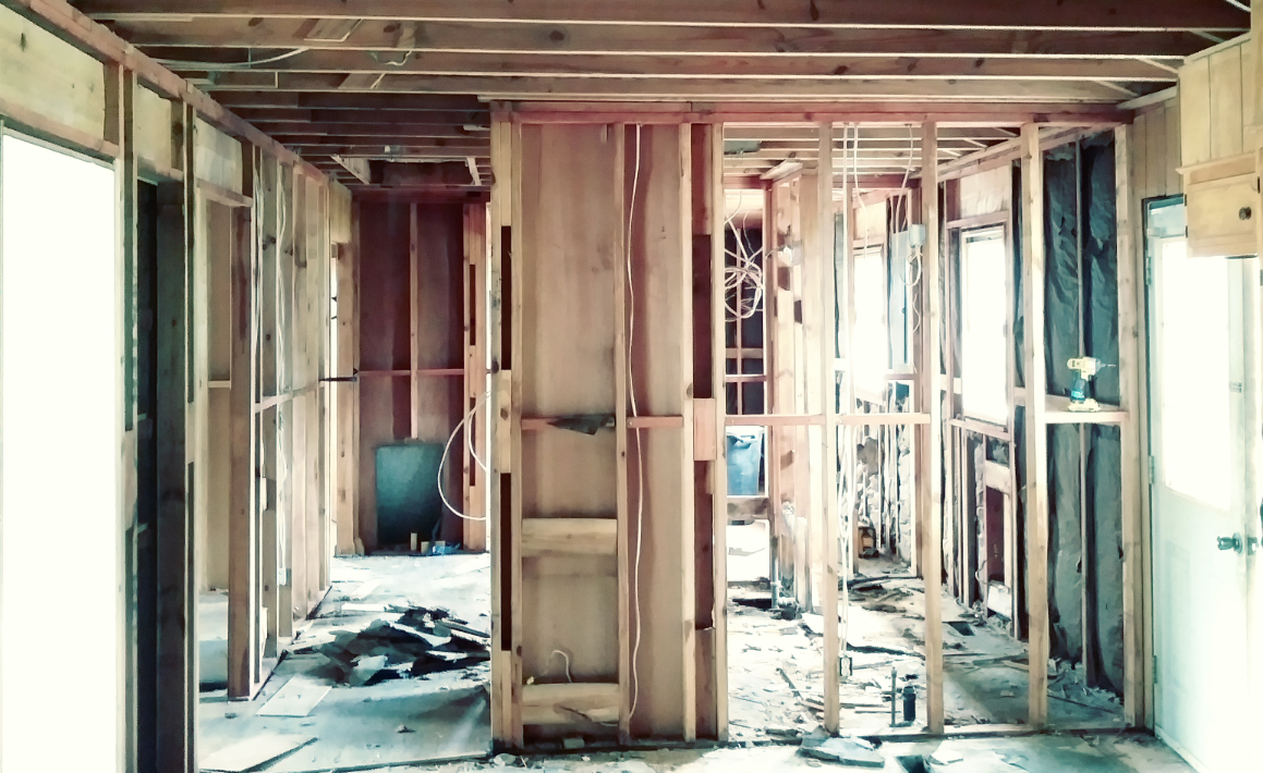 A house is being built with wooden beams and walls.