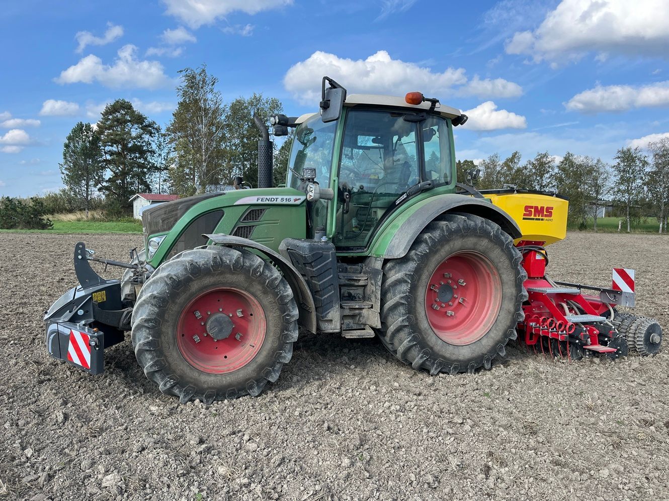 Fendt-traktori pellolla. Takana SMS Agro Smart Seeder -kylvökone ja edessä Tractor Bumper -turvapaino.