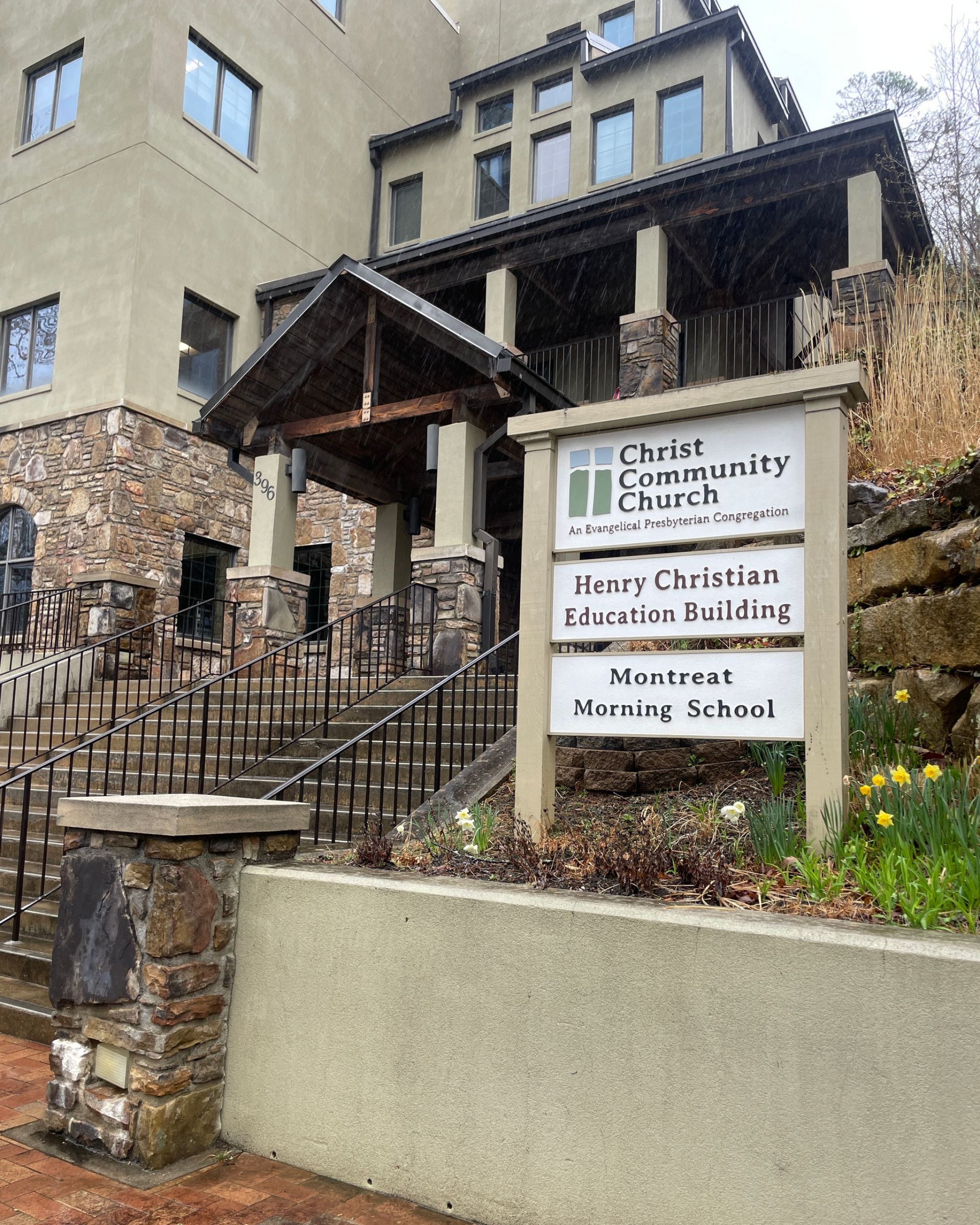 An exterior shot of a building with a sign for Christ Community Church and the Henry Building.