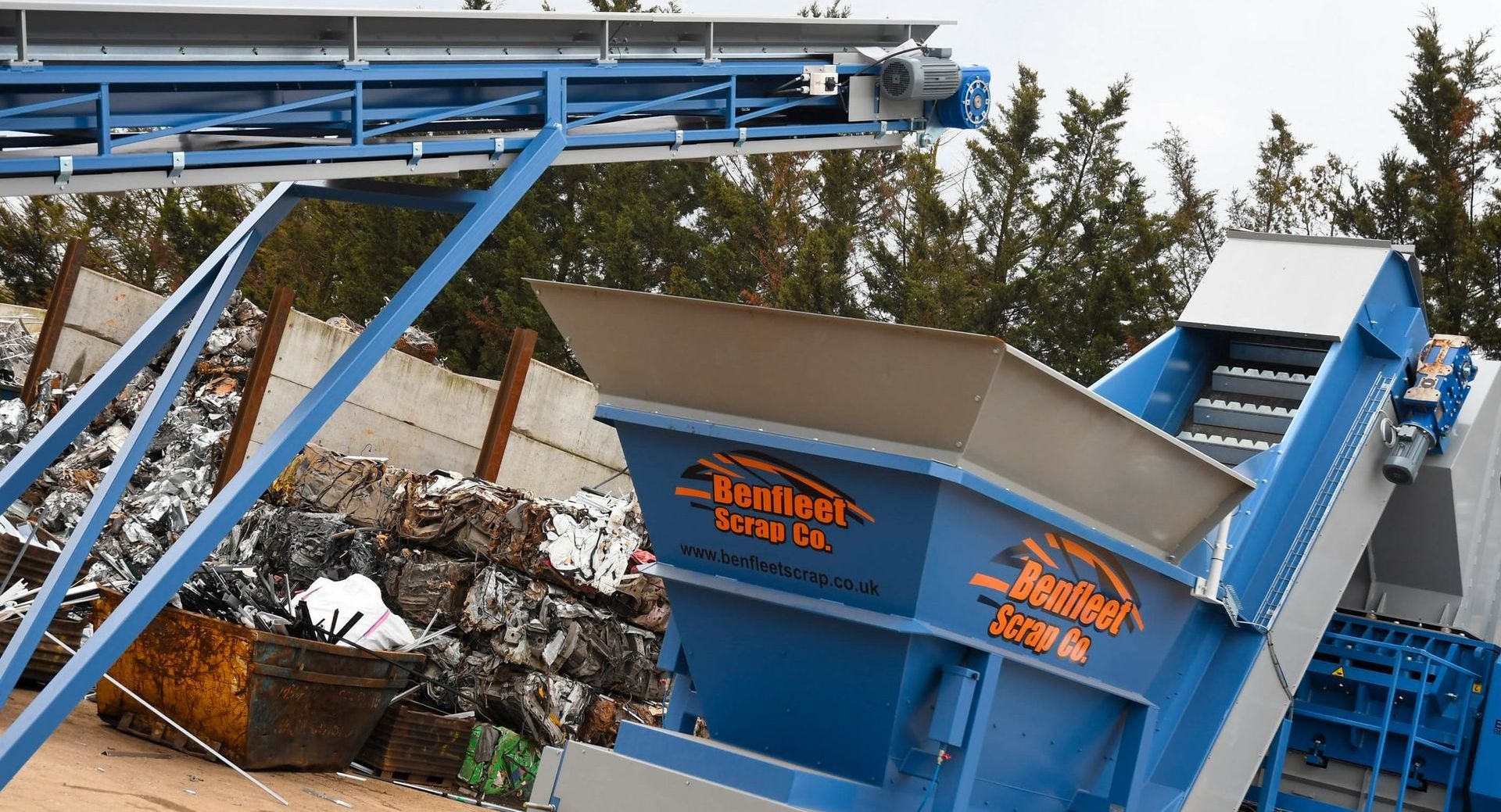 A blue and gray scrapping machine within Benfleet Scrap yard