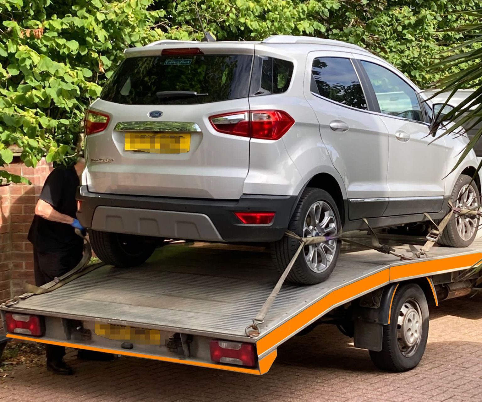 A silver suv is being towed by a tow truck taken to Benfleet Scrap yard.
