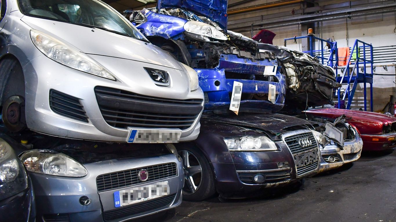 A bunch of cars are stacked on top of each other at Benfleet Scrap ready to be scrapped