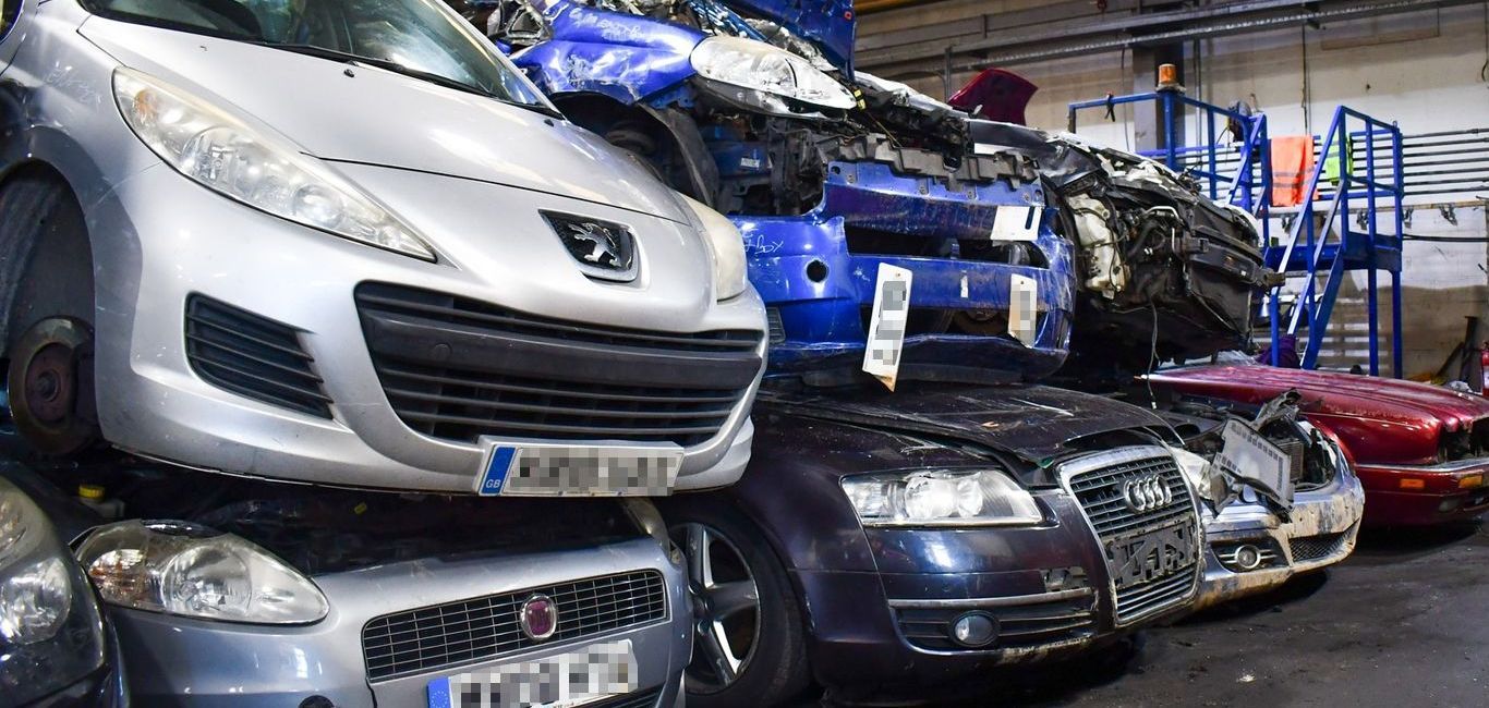 A bunch of cars are stacked on top of each other at Benfleet Scrap