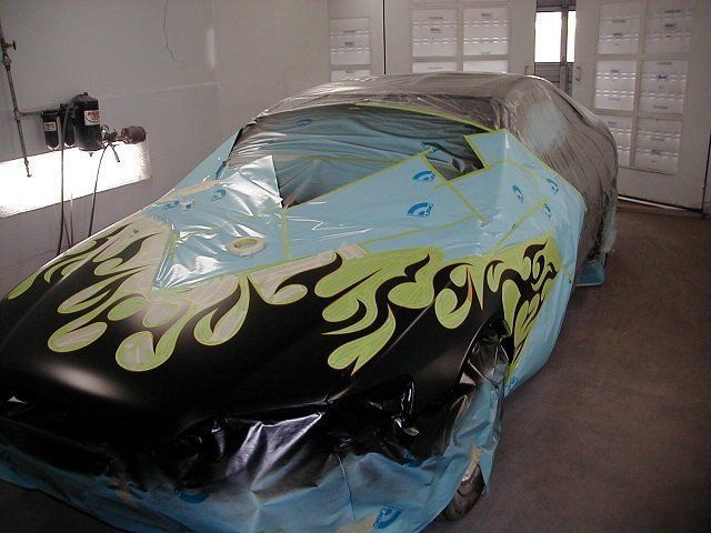 A black car with flames painted on it