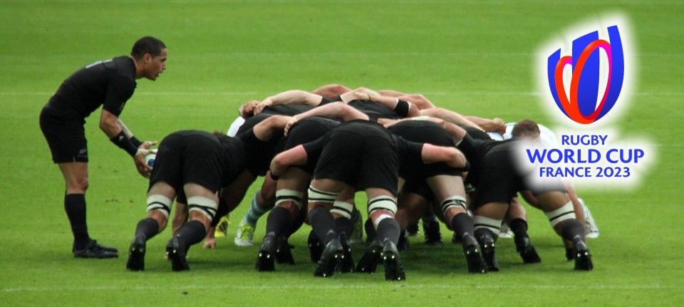 Rugby Players on field and Rugby World Cup 2023 logo