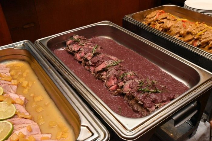A buffet-style meal with roast beef, roast ham, and other dishes as provided by caterer Shooters Sports Bar & Grill.