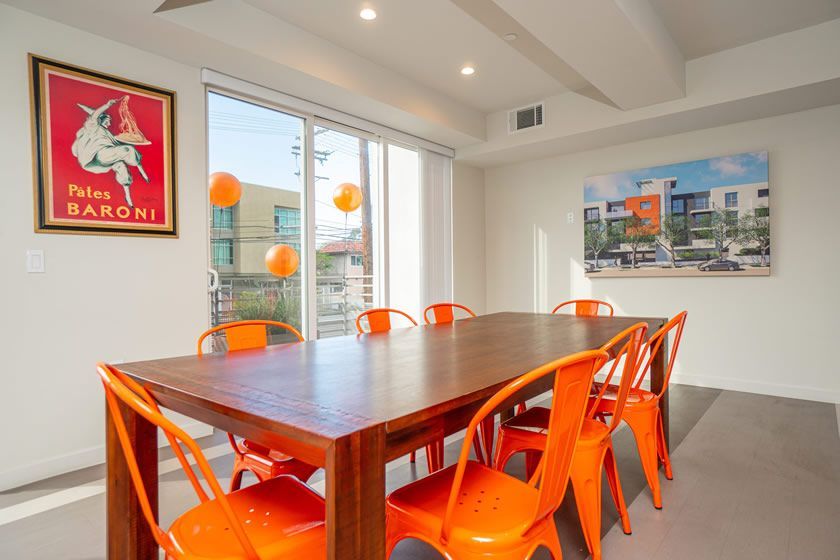 A room with a table and chairs and a poster on the wall that says 