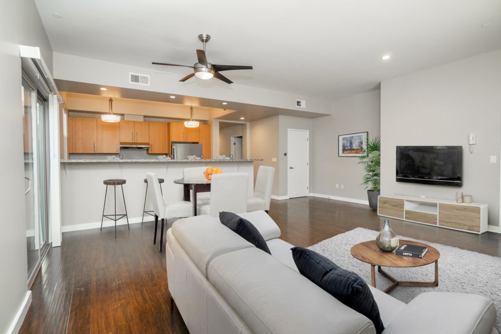 A living room with a white couch and a flat screen tv