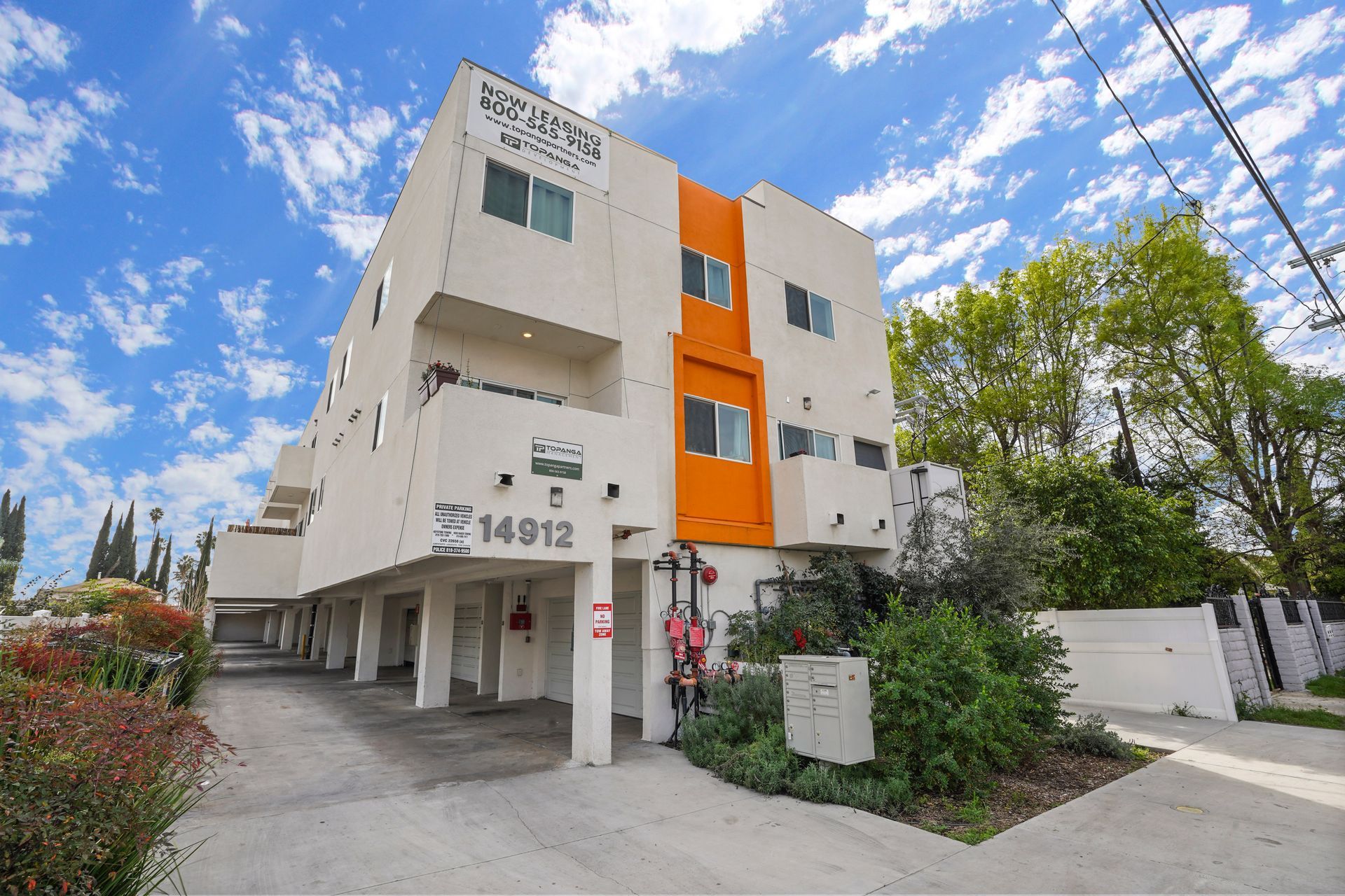 A large apartment building with a parking lot in front of it