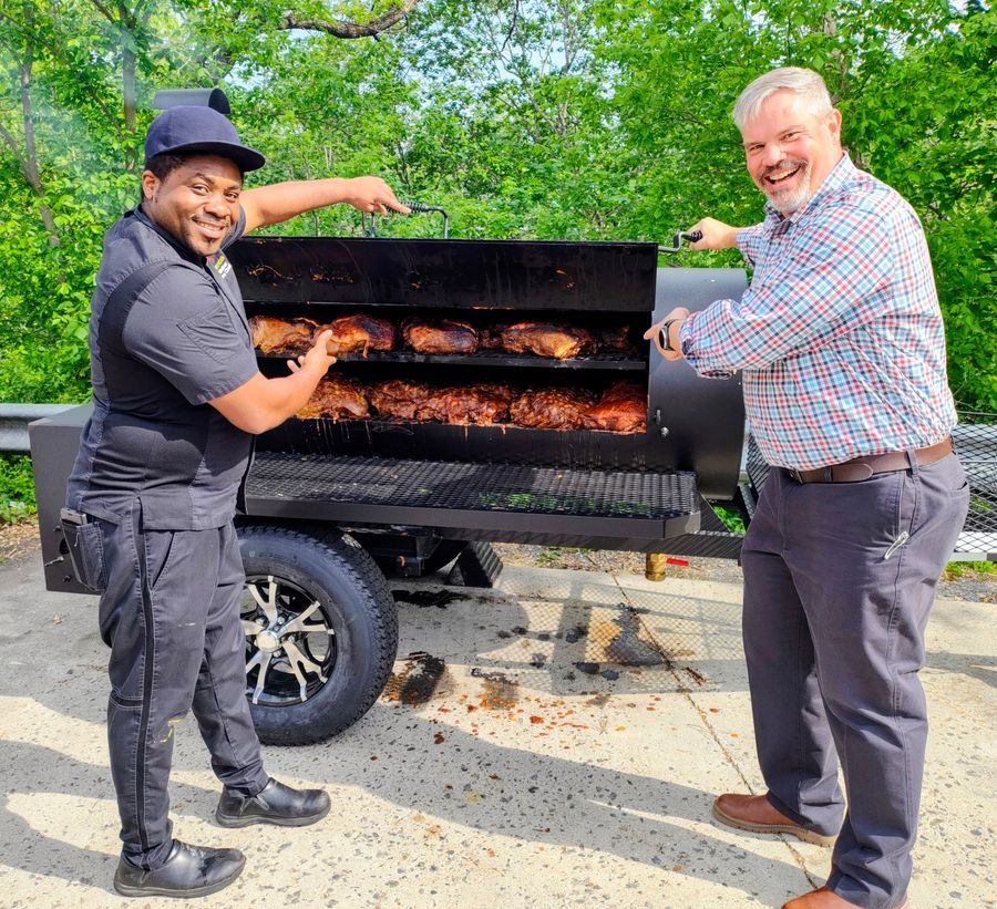 A man in a chef 's hat is posing for a picture with two other chefs