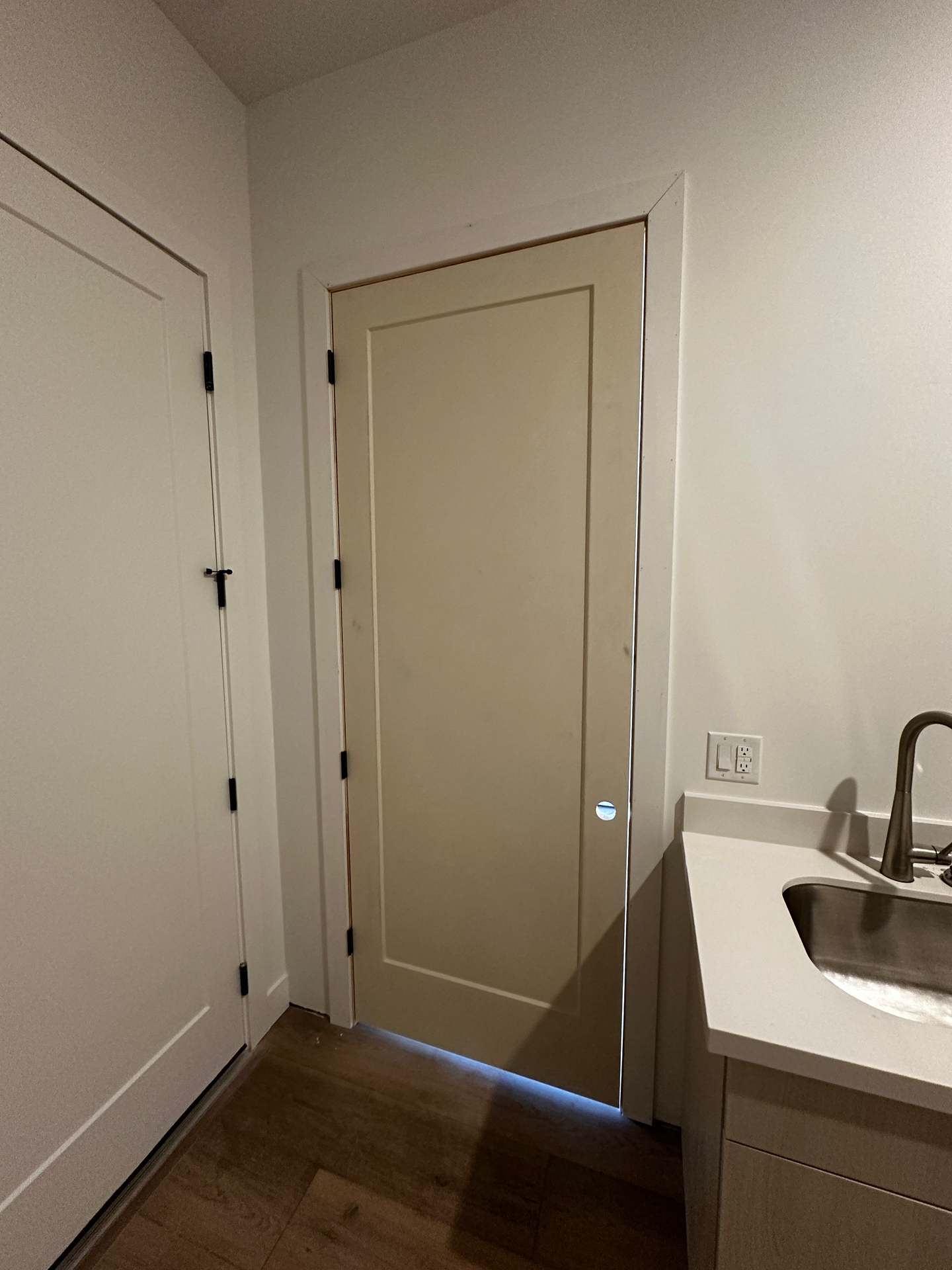 A bathroom with a sink and a white door