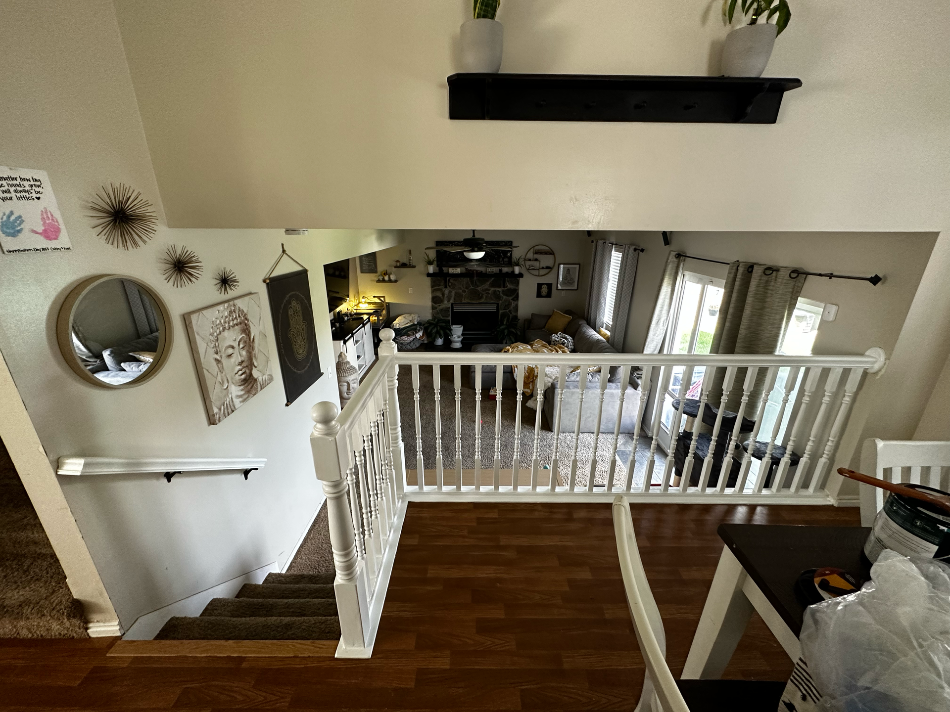 A view of a living room from the second floor of a house.