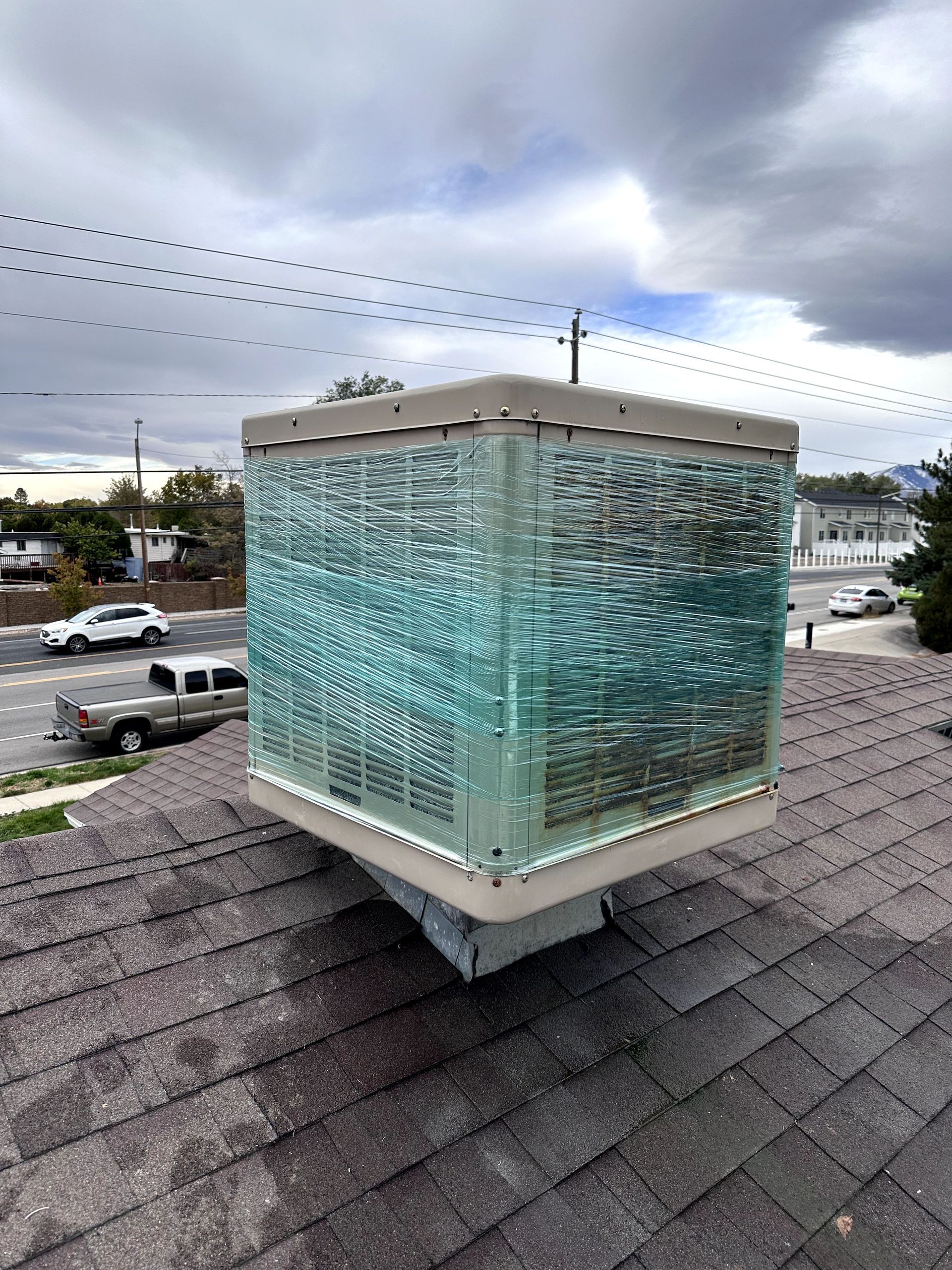 A roof with a glass cube on top of it