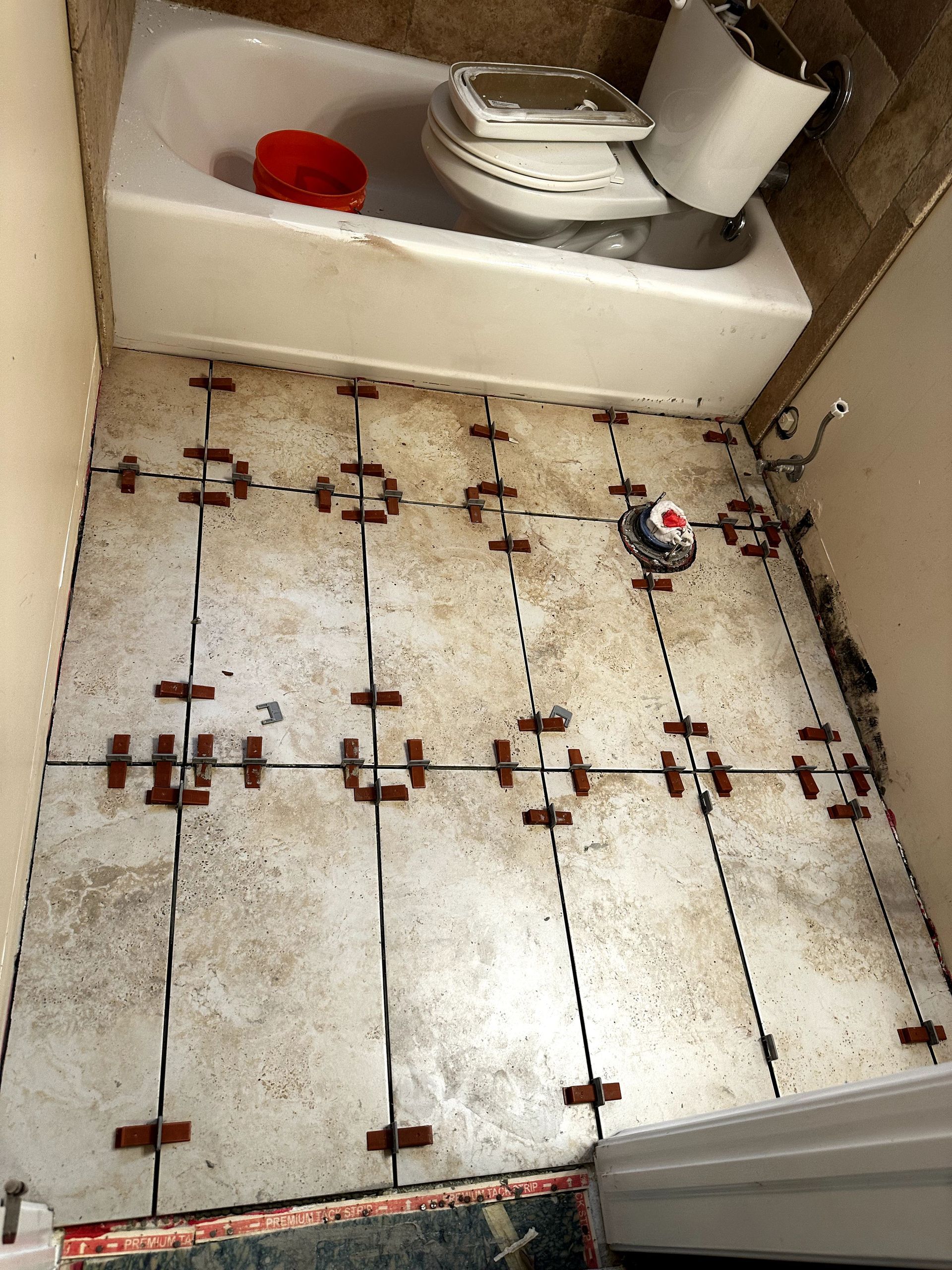 A bathroom with a toilet and bathtub being remodeled.