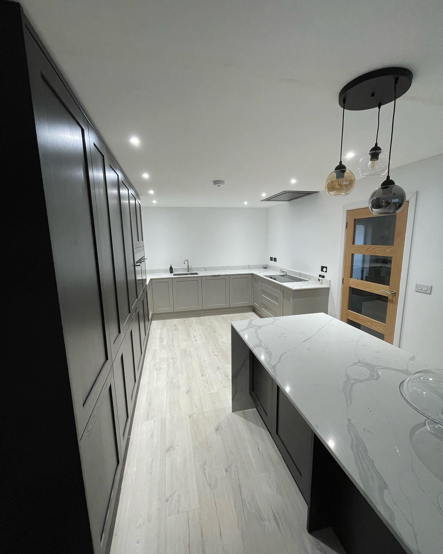 a kitchen with a long counter and a large island .