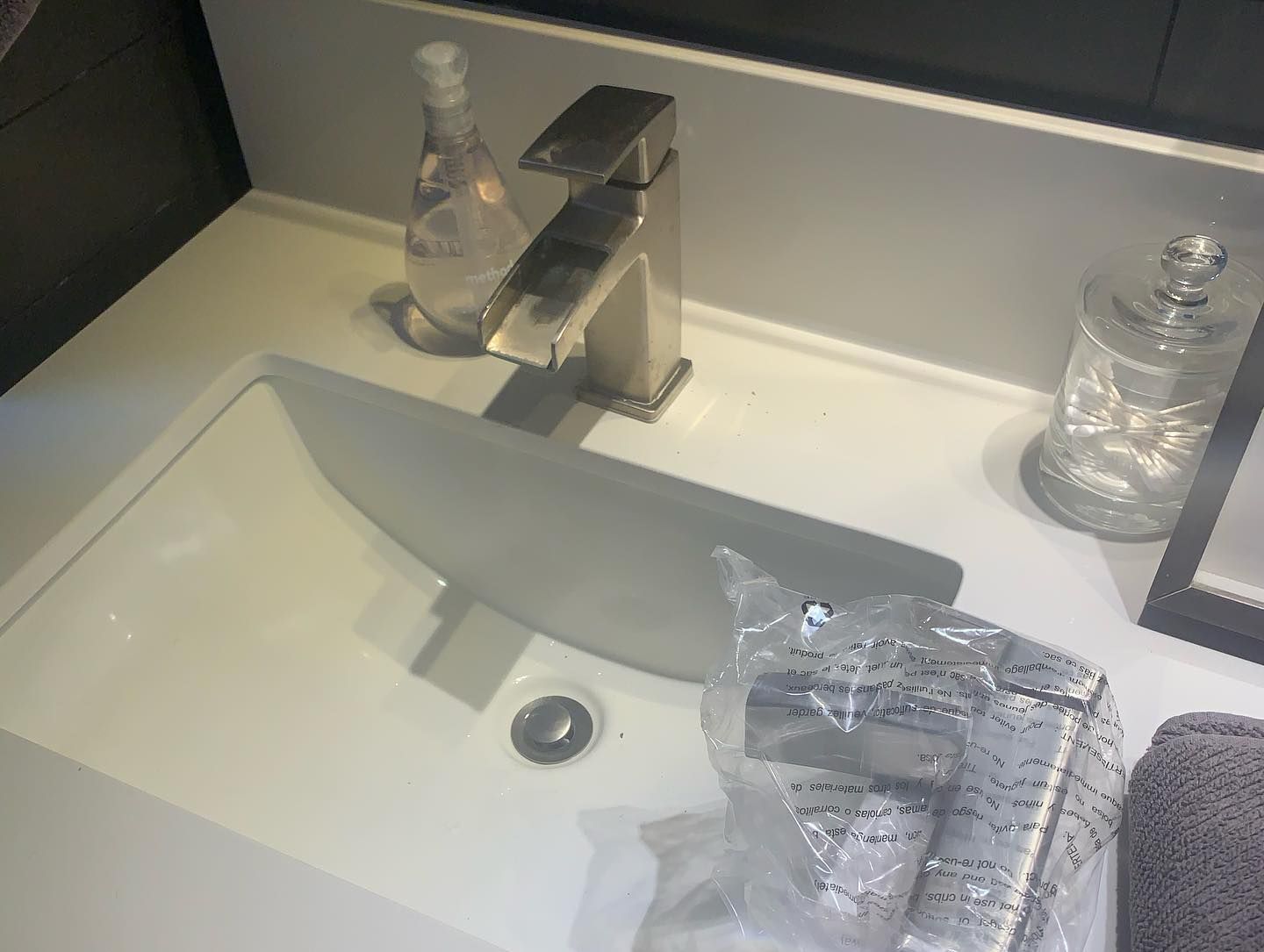 A modern bathroom sink with a silver faucet. 