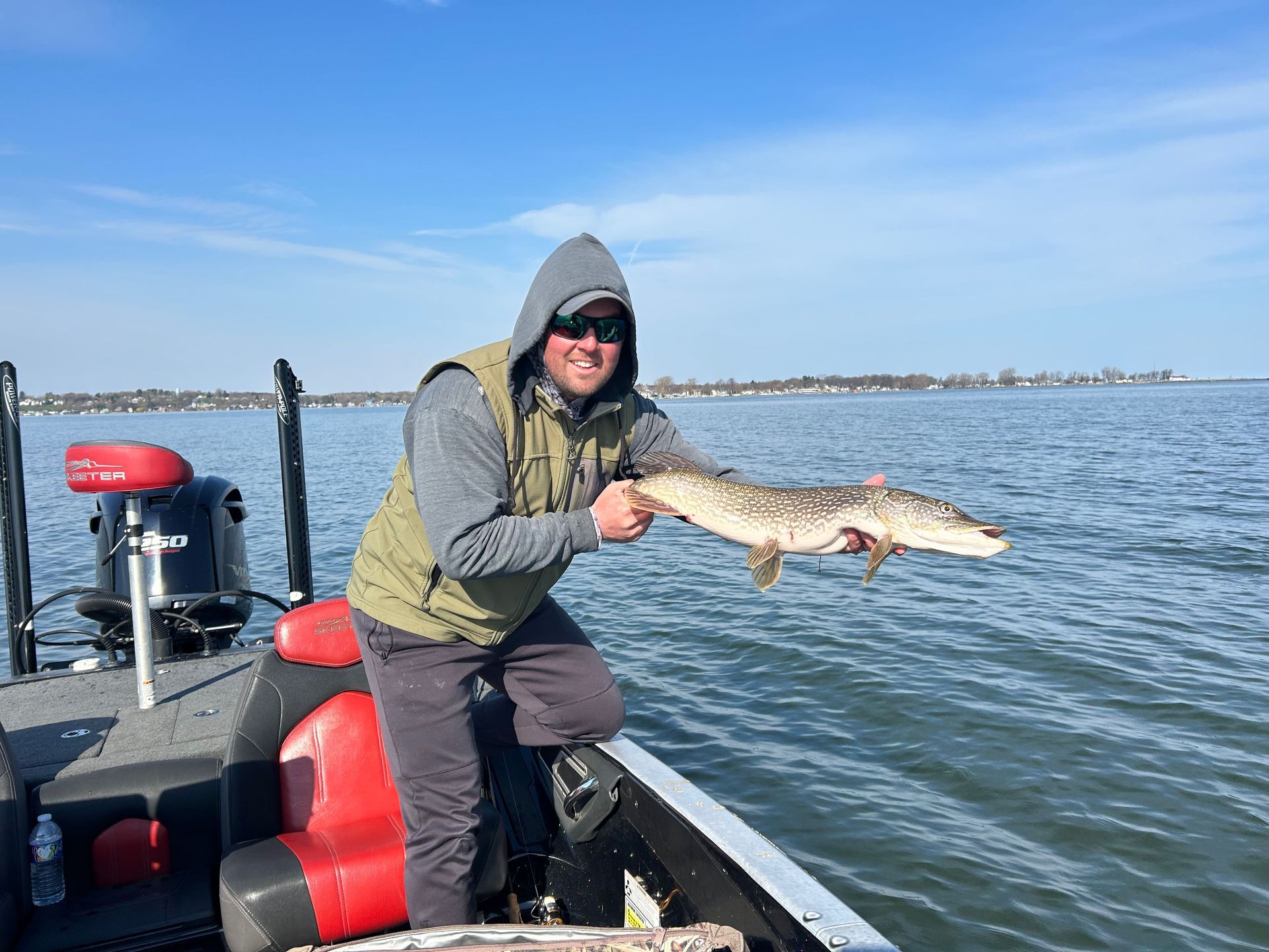man holding a fish above water