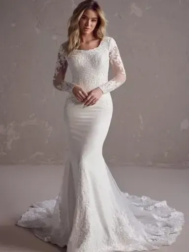 Woman in white mermaid wedding gown with lace sleeves and train.